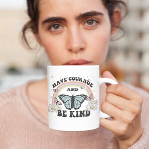 May include: White ceramic mug with a rainbow, butterfly, and the text "Have Courage and Be Kind".