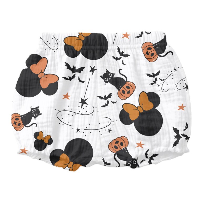 May include: White cotton baby bloomers with a Halloween print featuring black cats, pumpkins, stars, and Mickey Mouse ears with bows.