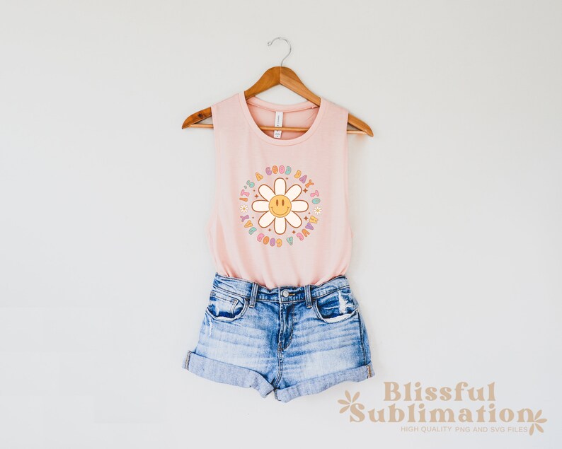 May include: A pink sleeveless tank top with a daisy graphic and the text "It's a good day to have a good day".