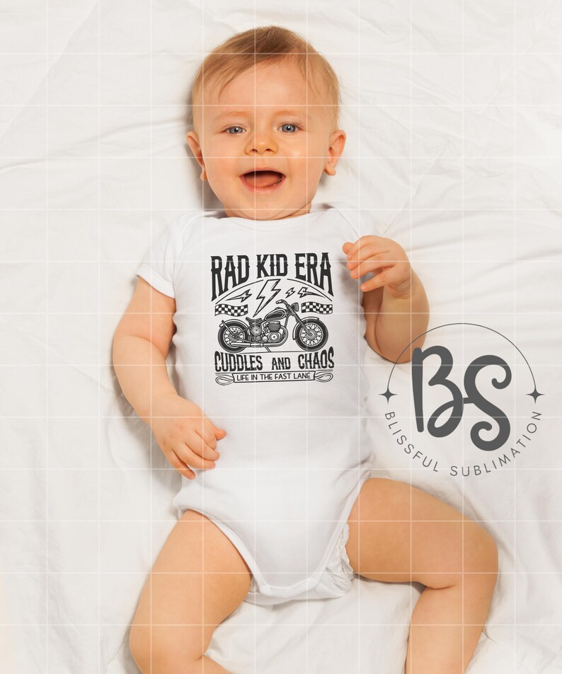 May include: A white baby onesie with a black graphic of a motorcycle and the text "Rad Kid Era Cuddles and Chaos Life in the Fast Lane".