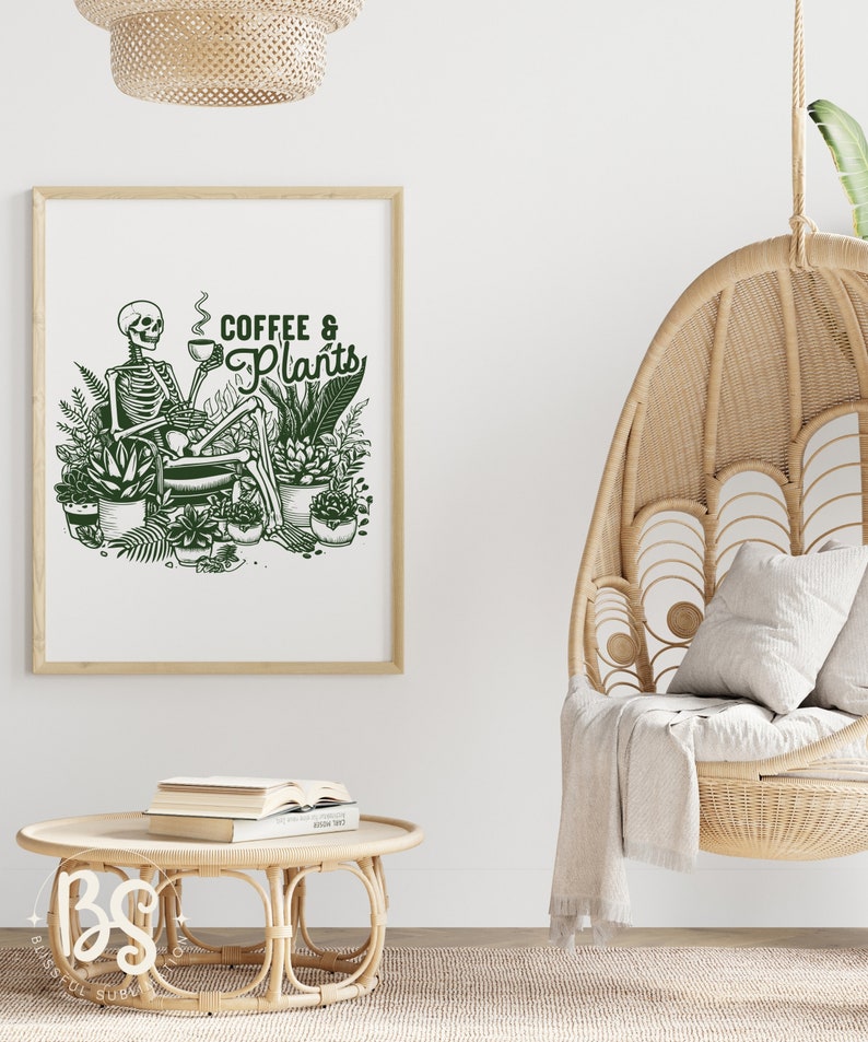 May include: A framed print with a green illustration of a skeleton sitting in a chair surrounded by plants and holding a cup of coffee. The text "Coffee & Plants" is written in green above the skeleton.