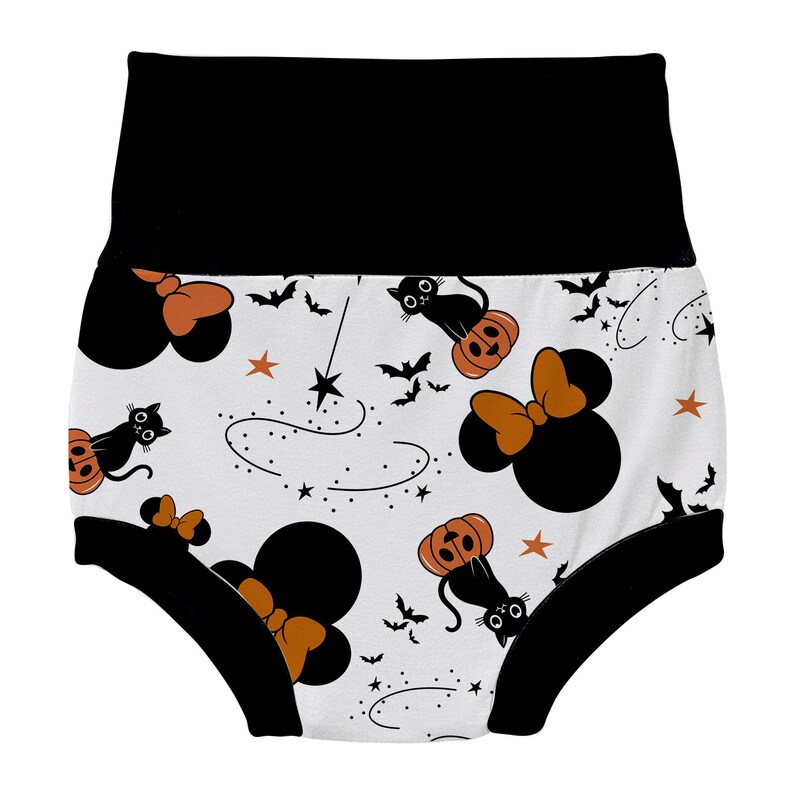 May include: White cotton baby bloomers with a black waistband and black trim. The bloomers feature a Halloween-themed print with black cats, pumpkins, stars, and Mickey Mouse ears with a bow.