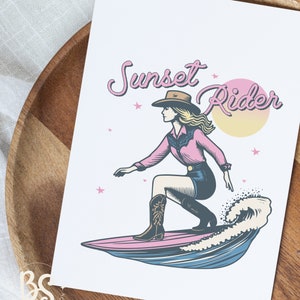Greeting card featuring a Surfing Cowgirl illustration, with a cowgirl surfing a wave and the text "Sunset Rider," great for personalized messages and gifts