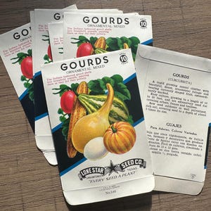 May include: A collection of vintage paper seed packets for ornamental mixed gourds from Lone Star Seed Co. Each white packet features a colourful illustration of various gourds, the text GOURDS ORNAMENTAL MIXED, and the Lone Star Seed Co. logo.