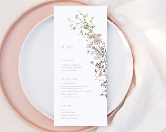 May include: A wedding menu card with a floral design. The menu includes starters, main course, and dessert options. The text on the card reads "MENU", "STARTERS", "MAIN COURSE", and "DESSERT".