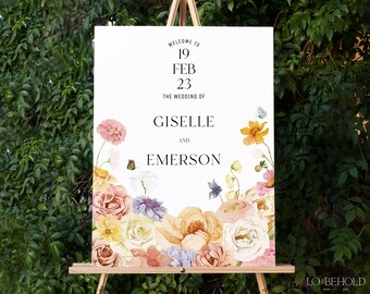 Peut inclure: Une pancarte de bienvenue de mariage avec un motif floral composé de fleurs roses, jaunes et blanches. La pancarte indique "Bienvenue au mariage de Giselle et Emerson, 19 février 23".