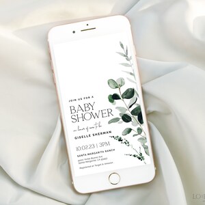 May include: A smartphone screen displaying a baby shower invitation with a green watercolor floral design. The invitation reads "Join us for a Baby Shower in honor of Giselle Sherman 10.02.23 | 3PM Santa Margarita Ranch Santa Margarita, CA 93453 Registered at Target & Amazon".