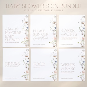 May include: A set of six white baby shower signs with floral accents. Each sign has text in a soft brown color, including "Welcome to Kimora's Baby Shower," "Please Sign Our Guest Book," and "Cards and Gifts."