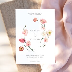 May include: Wedding invitation with a floral design featuring pink and white flowers. The invitation reads "You are invited to the wedding of Madeline and Benjamin, April 04, 2022. Santa Margarita Ranch, 2000 Terra Buena Ave, Santa Margarita, CA 93543. Reception to follow."