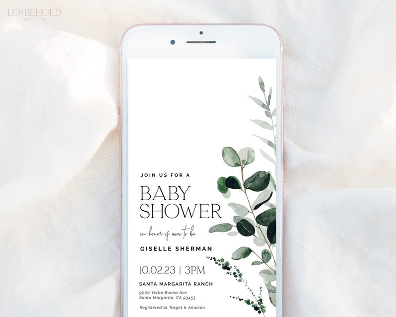 May include: A smartphone screen displaying a baby shower invitation with a leafy green watercolor design. The invitation reads "Join us for a Baby Shower in honor of mom-to-be Giselle Sherman 10.02.23 | 3PM Santa Margarita Ranch 9000 Yerba Buena Ave. Santa Margarita, CA 93453 Registered at Target & Amazon"