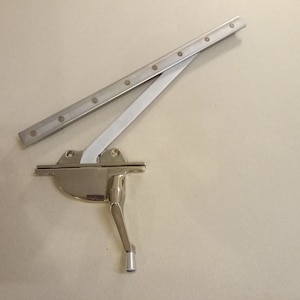 Casement window roto-operator, white bronze.