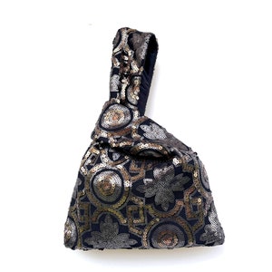 Sequin Japanese knot bag, wrist clutch in elegant fabric with arabic motif
