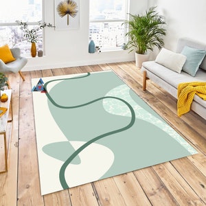 May include: Abstract area rug with a white background and green, wavy lines. The rug has a light green and white pattern.