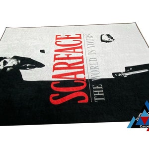 May include: Black and white rug with a red "Scarface" logo and the text "The World Is Yours".