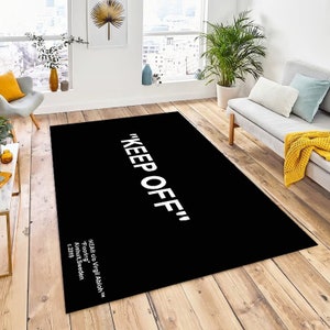 May include: Black and white rug with the text "KEEP OFF" in white lettering. The rug is designed by Virgil Abloh for IKEA.