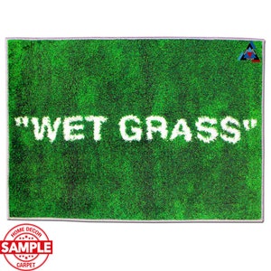 May include: Green doormat with the text "WET GRASS" in white lettering. The doormat is designed to look like grass.