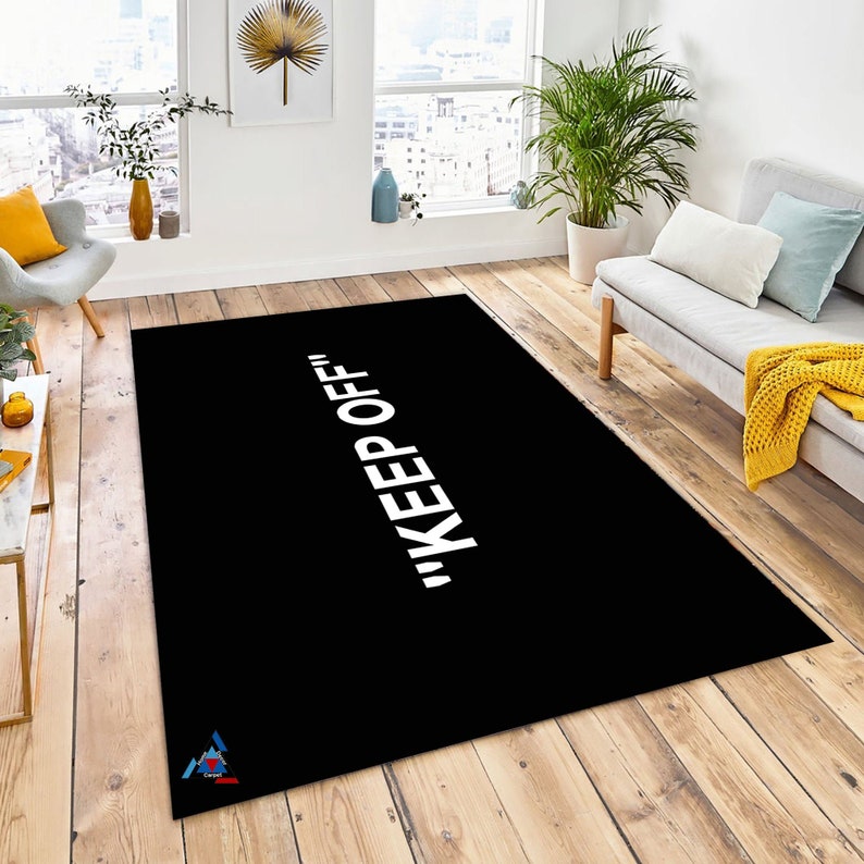 May include: Black and white area rug with the text "KEEP OFF!" in white lettering.