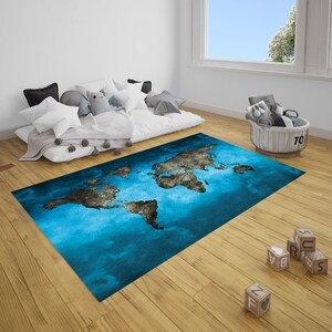 May include: A blue and grey world map rug with a distressed look. The rug is laid out on a wooden floor in a room with a white bed and a white wicker basket.