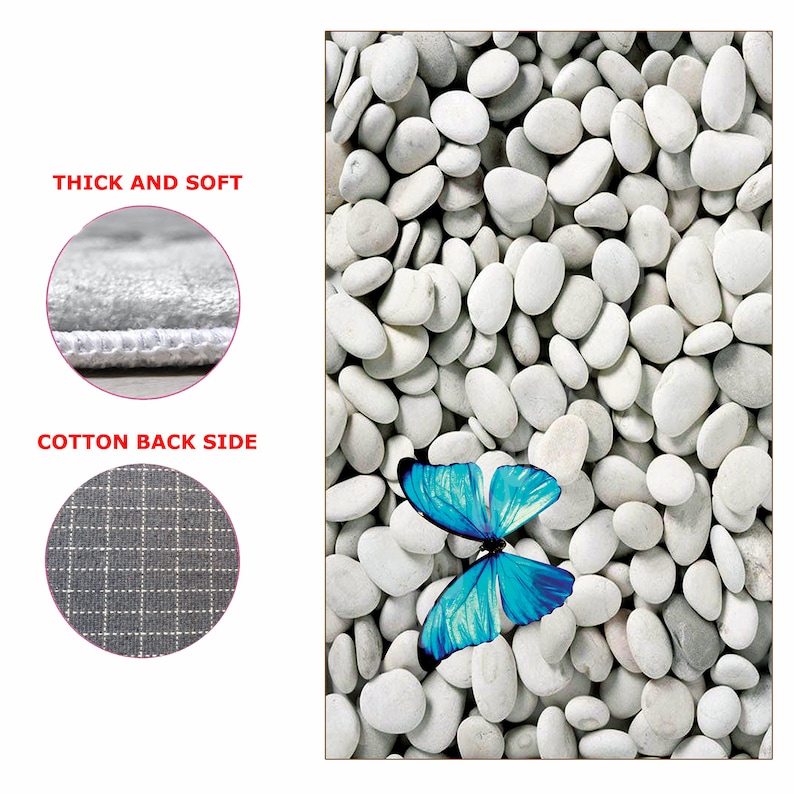 May include: A blue butterfly with white accents sits on a bed of white stones. The stones are smooth and round, and the butterfly is in the centre of the image.