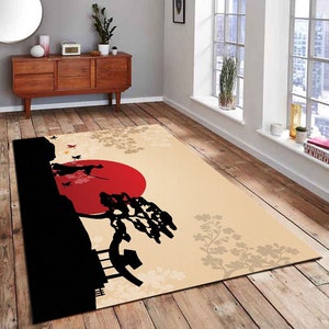 May include: A beige area rug with a black silhouette of a tree, a red sun, and two figures. The rug has a floral pattern in beige and brown.