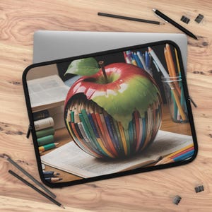 May include: A red and green apple with a bite taken out of it. The bite is filled with colorful pencils. The apple is sitting on a book with other books and pencils around it.