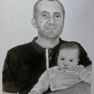May include: A pencil drawing of a man holding a baby. The man is wearing a dark polo shirt with a white collar. The baby is wearing a long-sleeved shirt. The drawing is in black and white.
