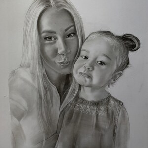 May include: Pencil drawing of a woman and a young child. The woman has long blonde hair and is puckering her lips. The child has a bun hairstyle and is making a funny face. The drawing is in grayscale.