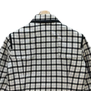 May include: A white and black checked jacket with black trim around the collar and shoulders.