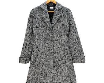 May include: A black and white tweed coat with a classic collar and long sleeves.