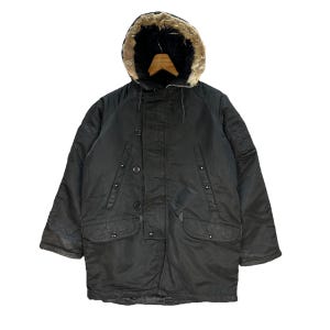 May include: A black parka with a fur-lined hood. The jacket has multiple pockets and a zipper closure.