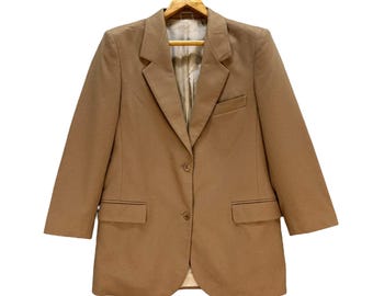 May include: A brown blazer with a single button closure and two pockets. The blazer has a classic, tailored fit.