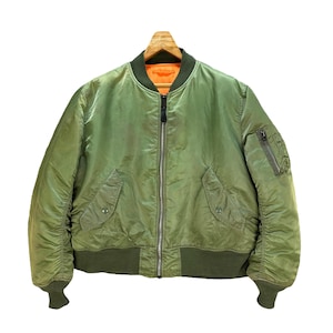 May include: A green bomber jacket with a zip fastening and a ribbed knit collar, cuffs, and waistband.