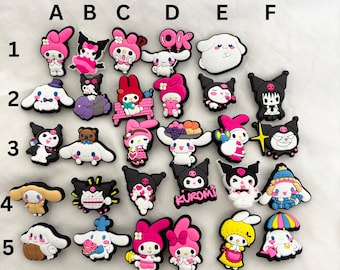 May include: A set of 25 colourful cartoon character shoe charms, featuring characters like Hello Kitty, My Melody, and Kuromi. The charms are made of rubber and have a variety of designs, including hearts, stars, and flowers.