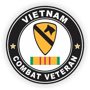 May include: A black and white circular sticker with the text "VIETNAM COMBAT VETERAN" around the edge. In the center is a yellow shield with a black diagonal stripe and a black horse's head. Below the shield is a green, red, and yellow ribbon.
