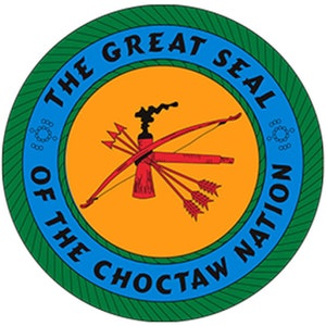 May include: The Great Seal of the Choctaw Nation features a red and black tomahawk with five arrows, set against a yellow background. The seal is surrounded by a blue circle with the words "The Great Seal of the Choctaw Nation" in white.