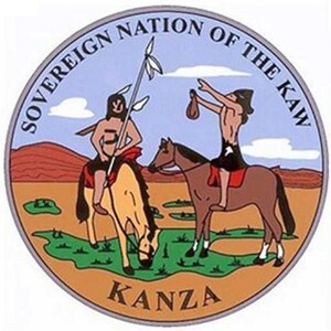 May include: A circular seal with a blue background and the text "Sovereign Nation of the Kaw" around the edge. The seal depicts two Native American figures on horseback, with the text "Kanza" at the bottom.