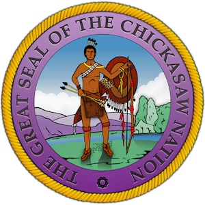 May include: The Great Seal of the Chickasaw Nation features a purple background with a gold rope border. Inside the seal, a Native American man stands holding a bow and arrow, with a shield on his back. The scene is set against a backdrop of mountains, a river, and a blue sky with clouds.