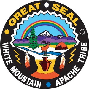 May include: A black and white circular seal with the words "Great Seal White Mountain Apache Tribe" around the edge. The seal depicts a rainbow over a mountain range with a pine tree and an elk in the foreground. There is a river flowing through the scene and a traditional Native American dwelling in the background.
