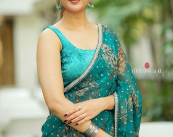 Peacock blue organza saree with velvet blouse