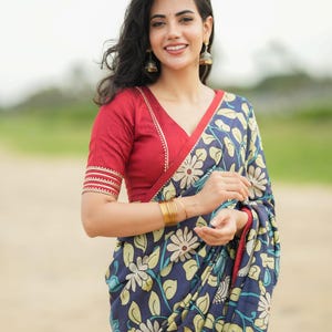 Blue dola silk kalamkari saree with maroon hand work blouse