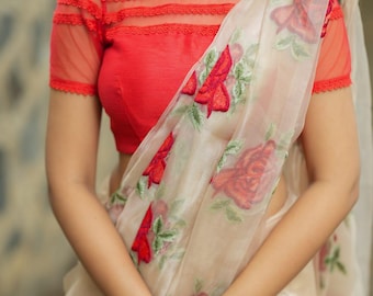 Glossy organza saree with red embroidery blouse