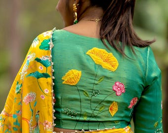 Yellow floral saree with green hand worked blouse