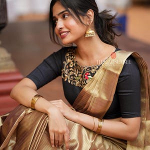 Golden tissue saree with black hand work blouse