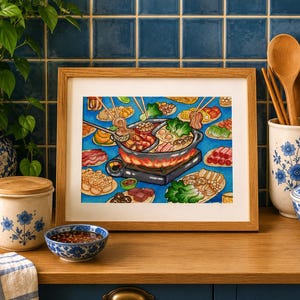 May include: A framed watercolor painting of a hot pot meal with various ingredients, including meat and vegetables, on a blue background. The painting is in a light brown wooden frame. The image is on a wooden surface with blue and white ceramic containers.