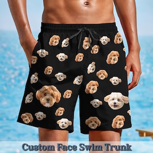 May include: Black swim trunks with a repeating pattern of dog faces. The dog faces are all different breeds and have a variety of expressions. The trunks have a drawstring waist and are made of a quick-drying fabric. Custom Face Swim Trunk.