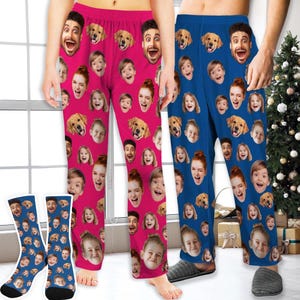 May include: A pair of pink and blue pyjama trousers with a repeating pattern of faces and dogs. The trousers are being worn by two people. The trousers are made from a soft, comfortable fabric and are ideal for relaxing at home.