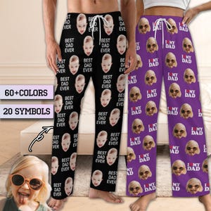 May include: Two pairs of pajama pants. One pair is black with a repeating pattern of a baby's face and the text "BEST DAD EVER". The other pair is purple with a repeating pattern of a person's face and the text "I MY DAD".