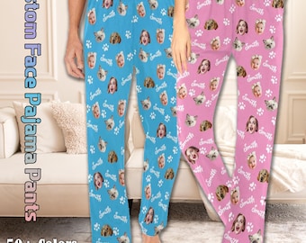 May include: Two pairs of pajama trousers, one blue and one pink, featuring a repeating pattern of faces, paw prints, and the name "Smith." The text "Custom Face Pajama Pants" and "50+ Colors" are also visible.