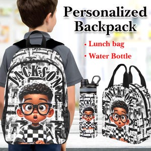 May include: A personalized backpack, lunch bag, and water bottle set. The black and white design features the name "Jackson" and a cartoon boy wearing glasses. The backpack is on a child's back.