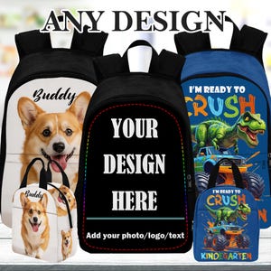 May include: Backpacks and lunch bags with customizable designs. One backpack features a corgi dog with the name "Buddy". Another has the text "Your Design Here". A third backpack and lunch bag display a dinosaur graphic with the text "I'm Ready to Crush".